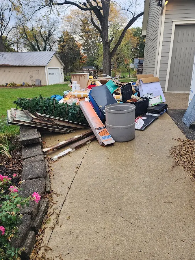 Dumpster being loaded with debris for Estate Cleanout Dumpster Rental in Ridgecrest